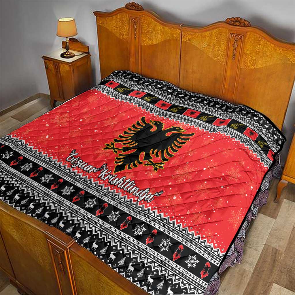 Red quilt blanket with Albanian eagle emblem and black-and-white patterned edge