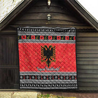 Red quilt blanket featuring Albanian eagle emblem, black-and-white festive border design