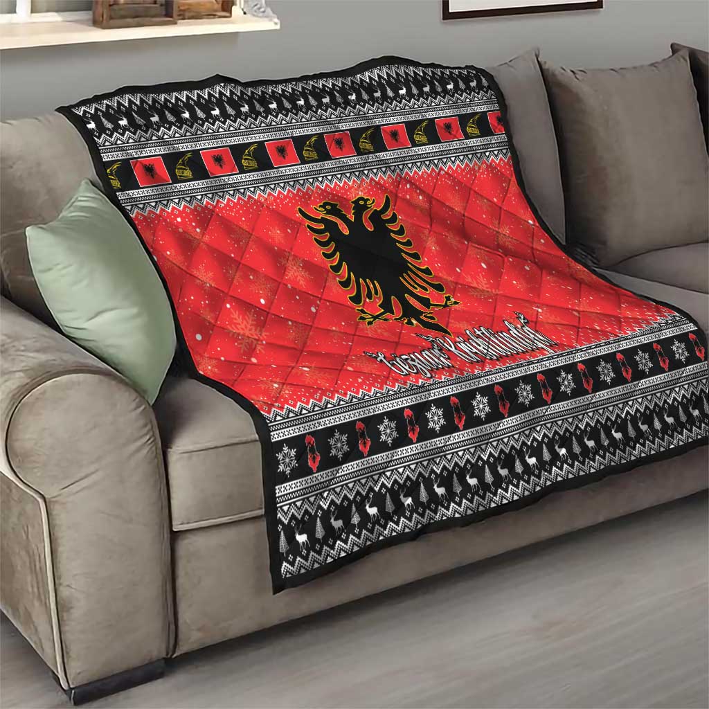 Red quilt blanket with black-and-white pattern bands and Albanian eagle center emblem