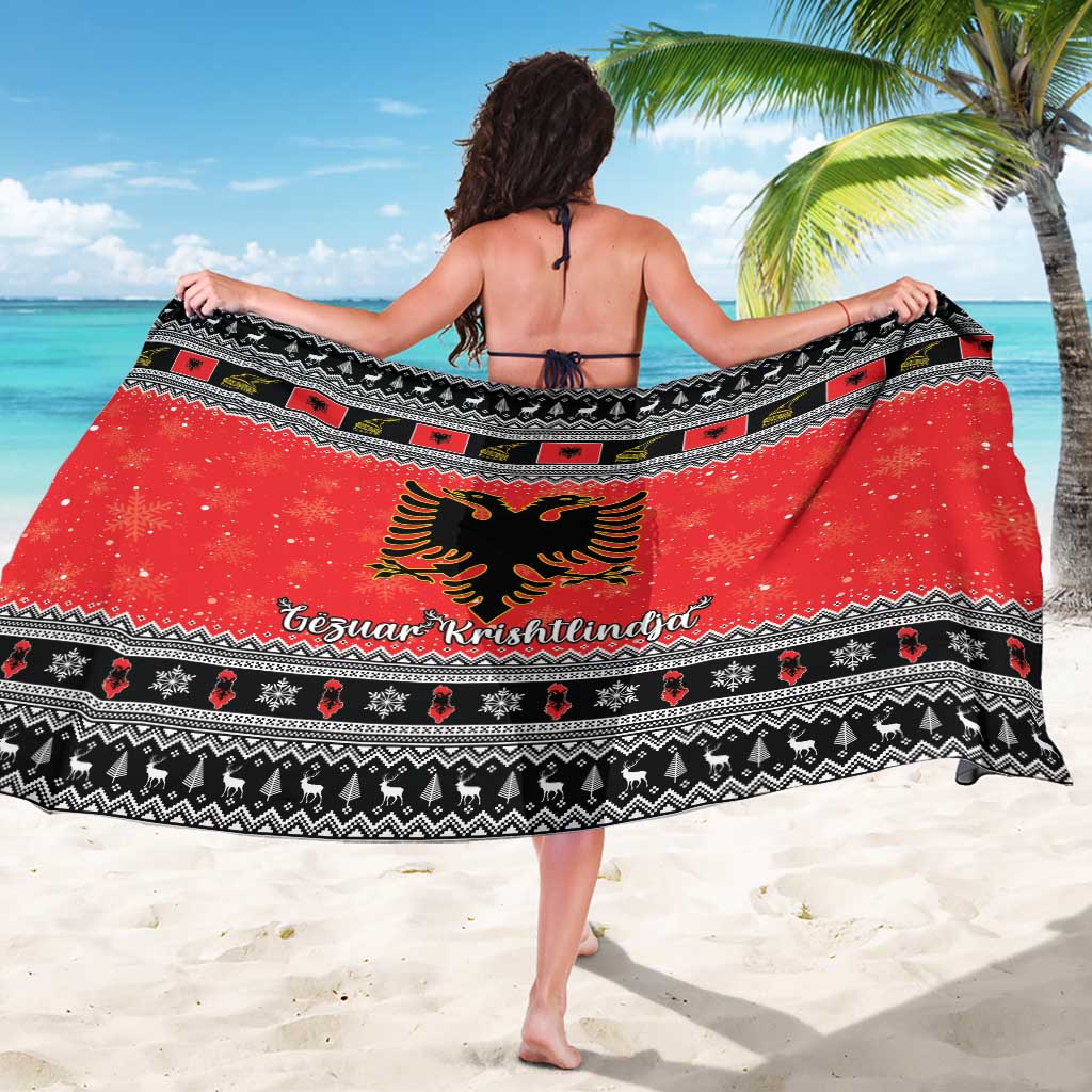 Red Christmas sarong with eagle crest, black geometric trim, and Gezuar Krishtlindja text