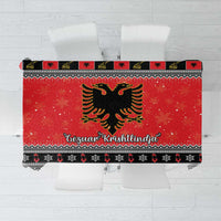 Red Christmas tablecloth with Albanian eagle, geometric trim, and festive lettering band.