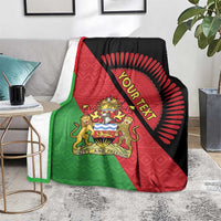 Throw blanket draped on sofa with Malawi crest and 'Your Text' circular emblem