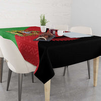 Dining table covered with black-edged tablecloth featuring Malawi coat of arms flag print