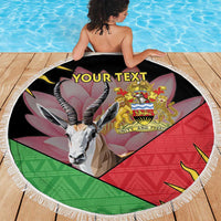 Black round beach blanket with fringe, gazelle head and Malawi coat of arms, 'YOUR TEXT'.