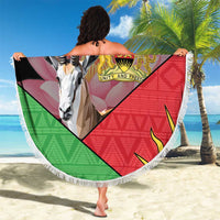 Black circular beach blanket with multicolor geometric bands and fringe, gazelle, 'YOUR TEXT'.