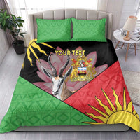 Full bedding set with green geometric pillows and black, red, and yellow gazelle-and-emblem duvet cover
