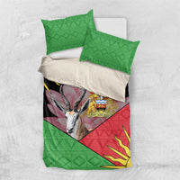 Flat-lay bedding set showing green geometric pillowcases and a black-red duvet with gazelle emblem