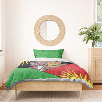 Single bed bedding set with green geometric pillowcases and a black-red-yellow gazelle design duvet