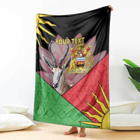Personalized black blanket held up with Malawi crest, antelope face, red and green triangle pattern