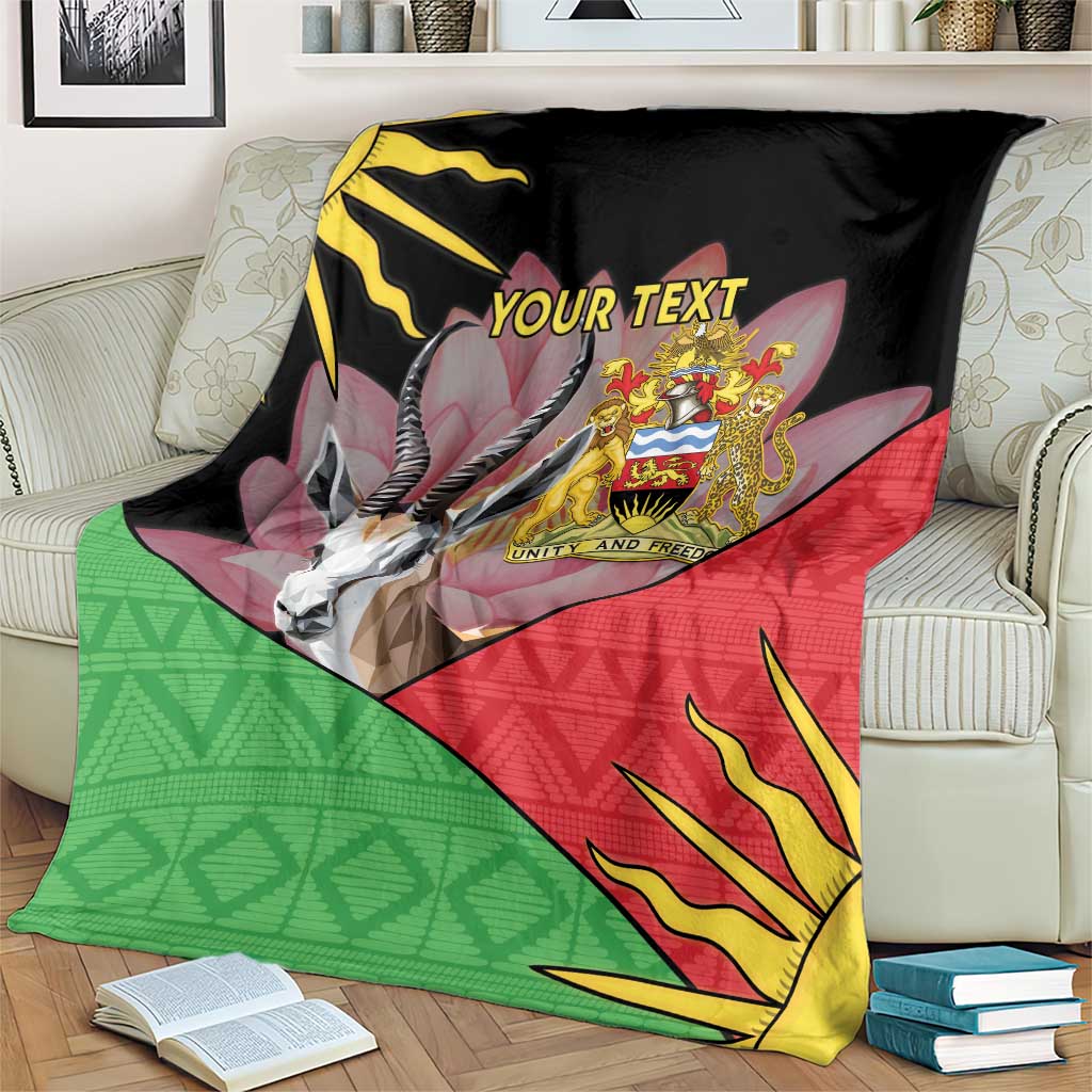 Personalized black blanket on couch showing Malawi crest, antelope graphic, red and green design