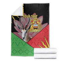 Personalized black blanket stacked with Malawi crest, antelope graphic, red and green geometric design