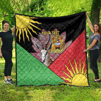 Black quilt spread outdoors with green-red-yellow Africa graphic, flame sun corner and custom text