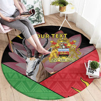 Round black area rug with African emblem, multicolor graphic, custom text, and antelope