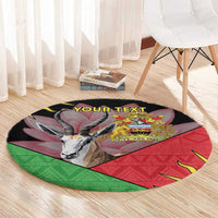 Round black area rug with African emblem, multicolor graphic, and custom text