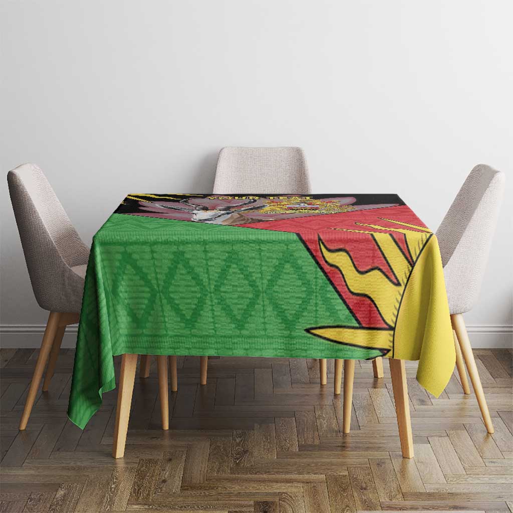 Personalised Malawi tablecloth on dining table, green geometric section and yellow sun burst