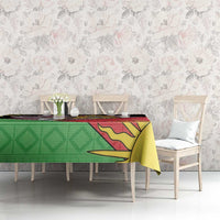Personalised Malawi tablecloth on long table, green geometric and red flag print with yellow rays