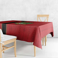 Red tablecloth with black side stripe and Malawi crest, draped over table edge.