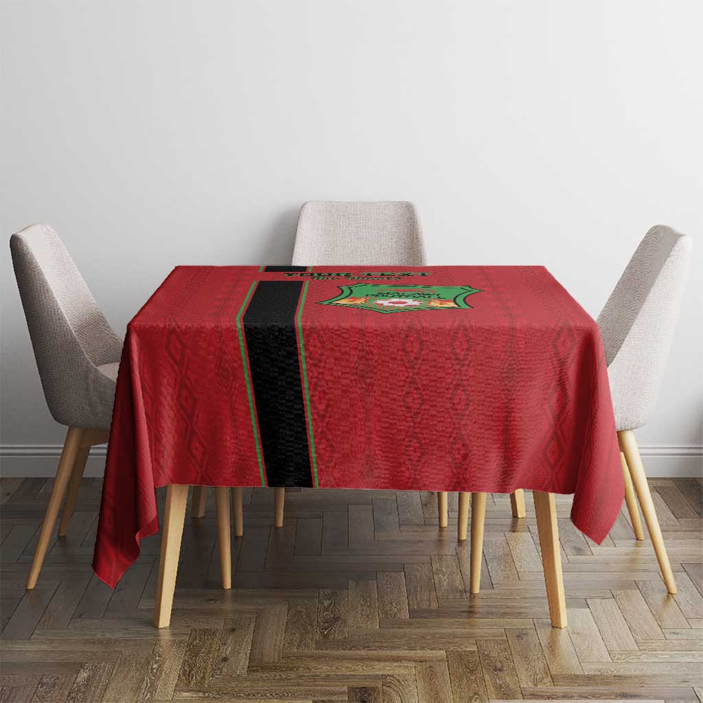 Red football tablecloth with Malawi crest and black-yellow stripe centered on table.