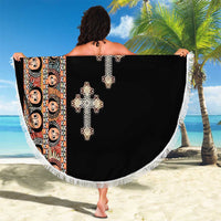 Round black beach blanket with white fringe and patterned edge panel with cross motifs