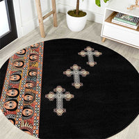 Black round carpet with beige embroidered cross pattern and border stripe on edge