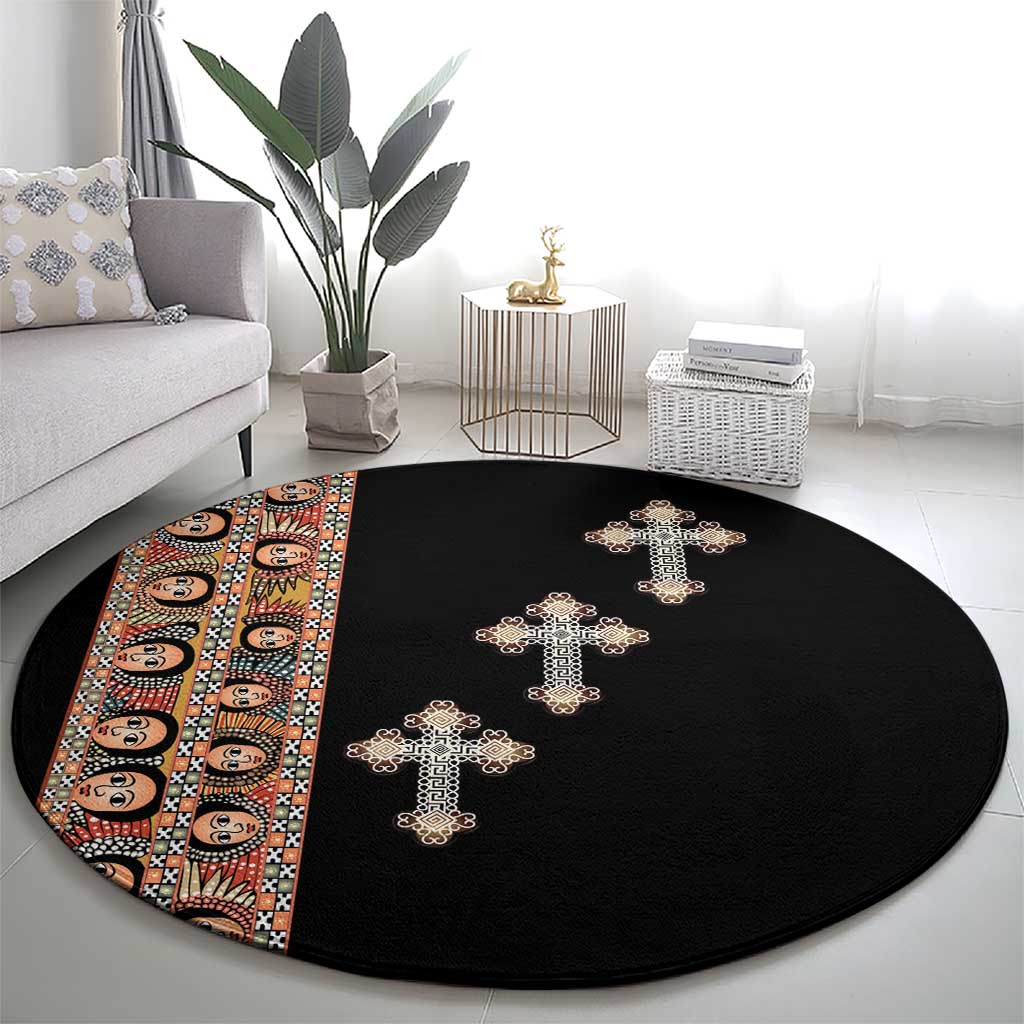 Black round carpet with multiple beige embroidered crosses and patterned end stripe