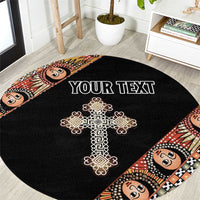 Black round carpet with gold ornate cross, angel face border and centered custom text