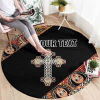 Black round carpet with ornate cross, angel face border, centered custom text