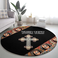 Black round carpet with ornate cross and angel face border, custom text