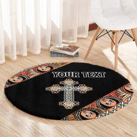 Black round carpet with ornate cross, angel face border, custom text center