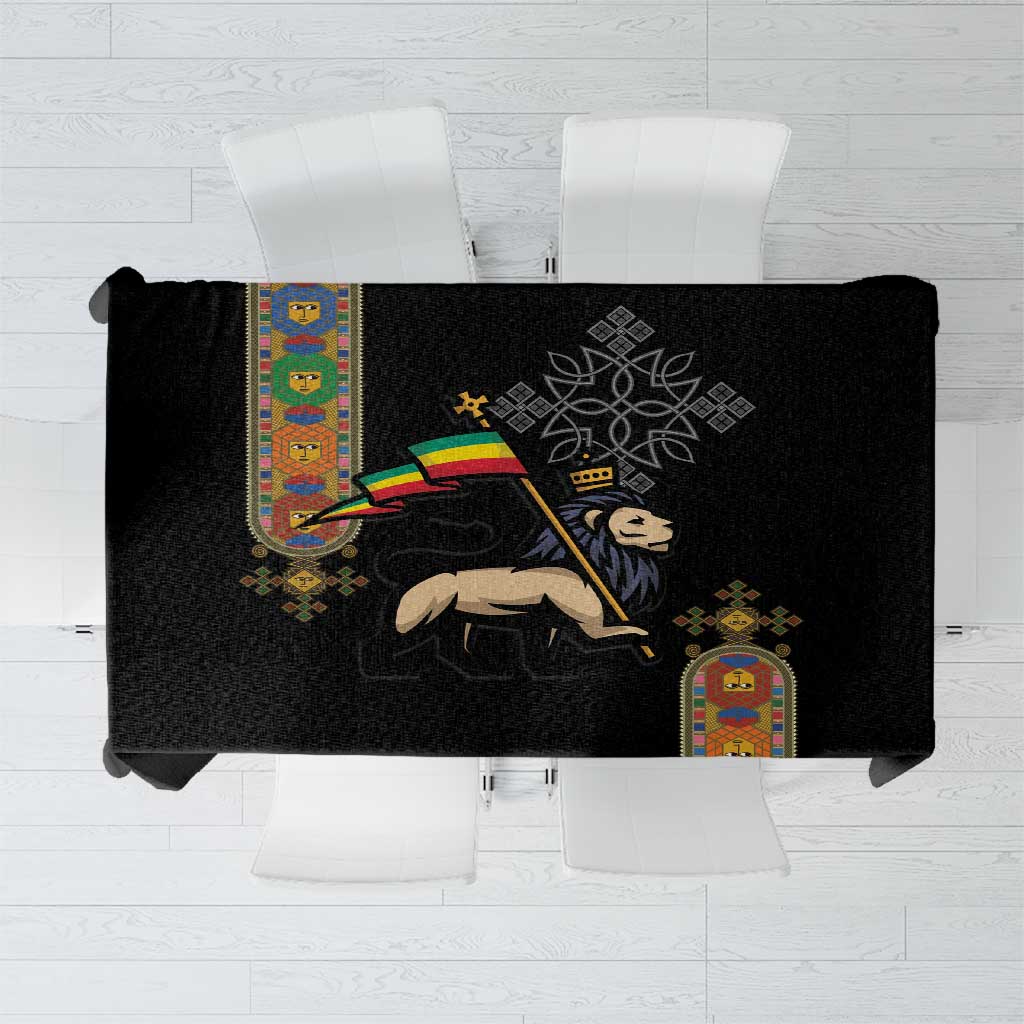 Black tablecloth with colorful vertical runner and Ethiopian-style cross and lion motifs