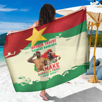 Green, red, and cream graphic sarong with text and map design, worn as wrap