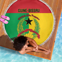 Round beach blanket with Guinea-Bissau flag emblem, framed by white fringed edge