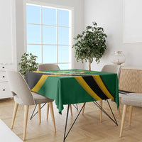 Green football tablecloth covering dining table with yellow and black team-style print