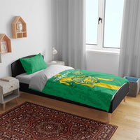 Green bedding set on bed with lion and shield graphics across the duvet cover