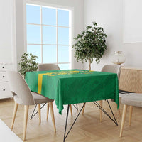 Green football tablecloth with yellow stripe and crest on a rectangular table