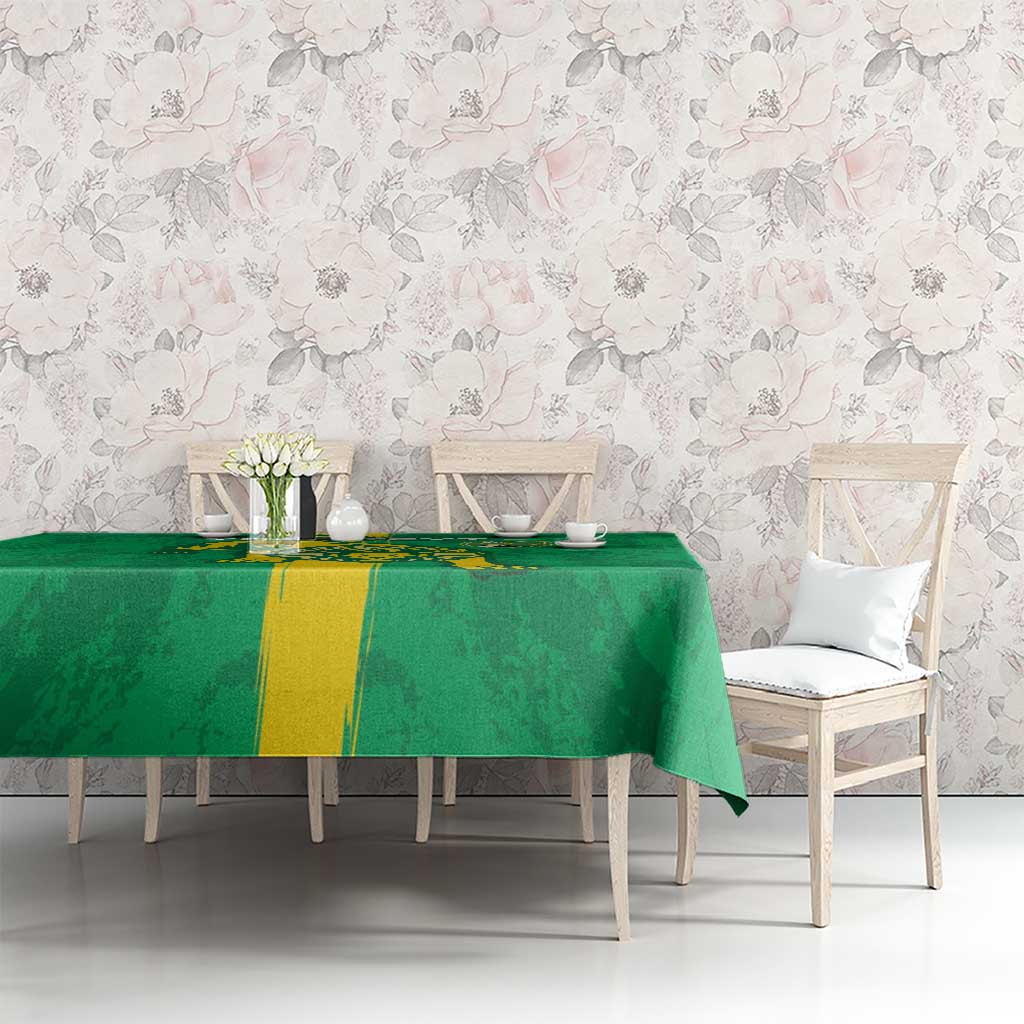 Green football tablecloth with yellow stripe and crest over a dining table