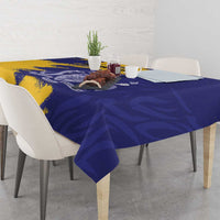 Rectangular tablecloth with blue and yellow crest flag motif over dining table