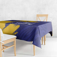 Tablecloth close-up on dining table, blue and yellow flag-style coat of arms