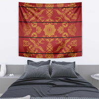 Red tapestry blanket with gold traditional symbols and horizontal stripe design