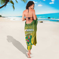 Green striped sarong tied at waist with Dominica team logo