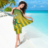 Green and yellow striped sarong with Dominica text and crest, draped at side