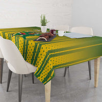 Green and yellow cricket tablecloth draped over a dining table with matching pattern