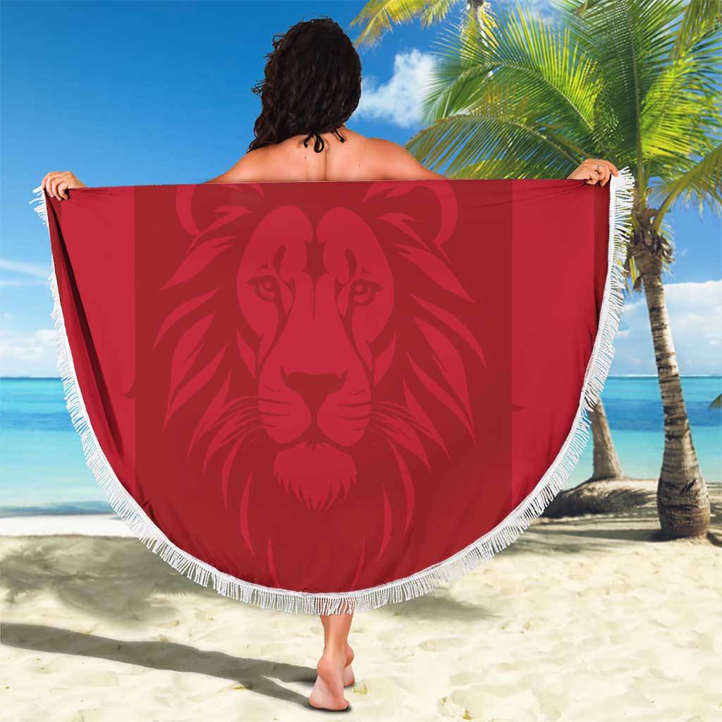 Red round beach blanket with white fringe; large lion graphic with Liberia crest and 'YOUR TEXT'.