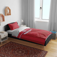 Red bedding set on bed with matching duvet and 'YOUR TEXT' stripe design