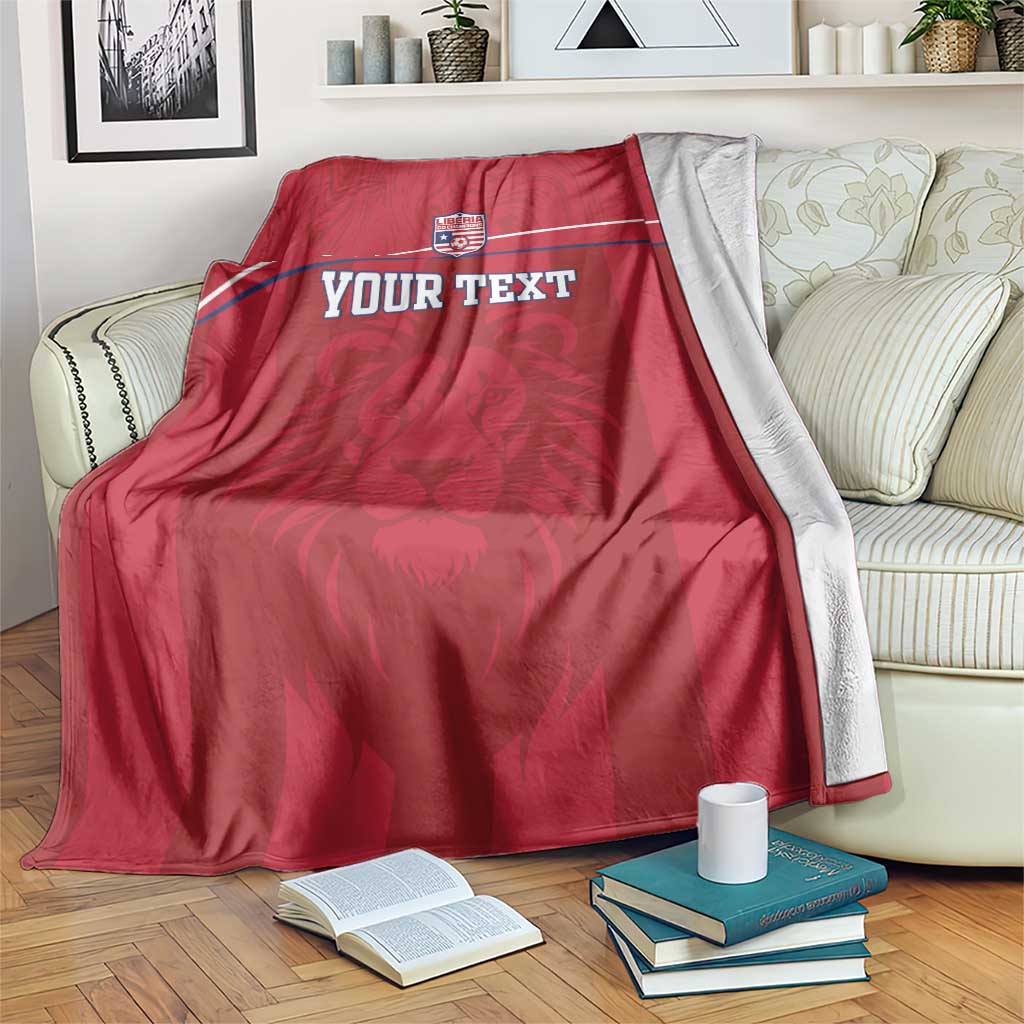 Red football blanket with Liberia crest, lion motif, and custom text across front