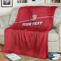 Red football blanket showing Liberia crest, lion graphic, and custom text on bed