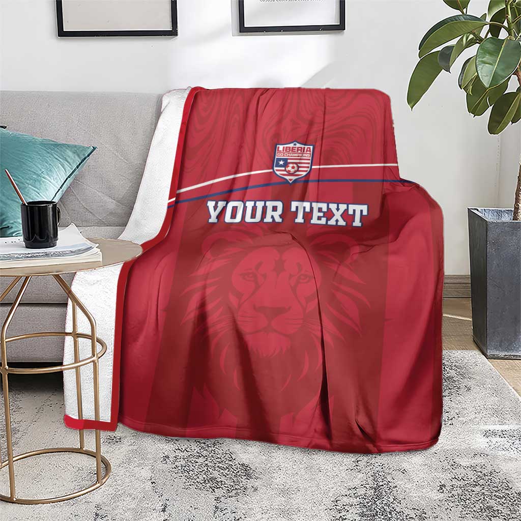 Red Liberia blanket draped on couch, lion mascot art and custom text