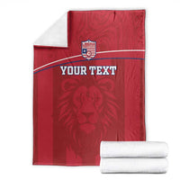 Red Liberia football blanket with lion crest and custom text, folded with white towels