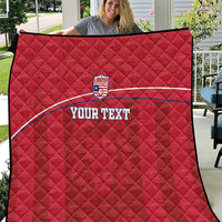 Red quilted football blanket with Liberia crest and custom text, diamond stitch pattern.