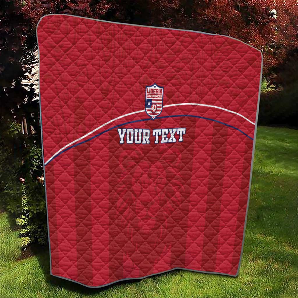 Red quilted football blanket with Liberia crest and 'YOUR TEXT' on curved white stripe.